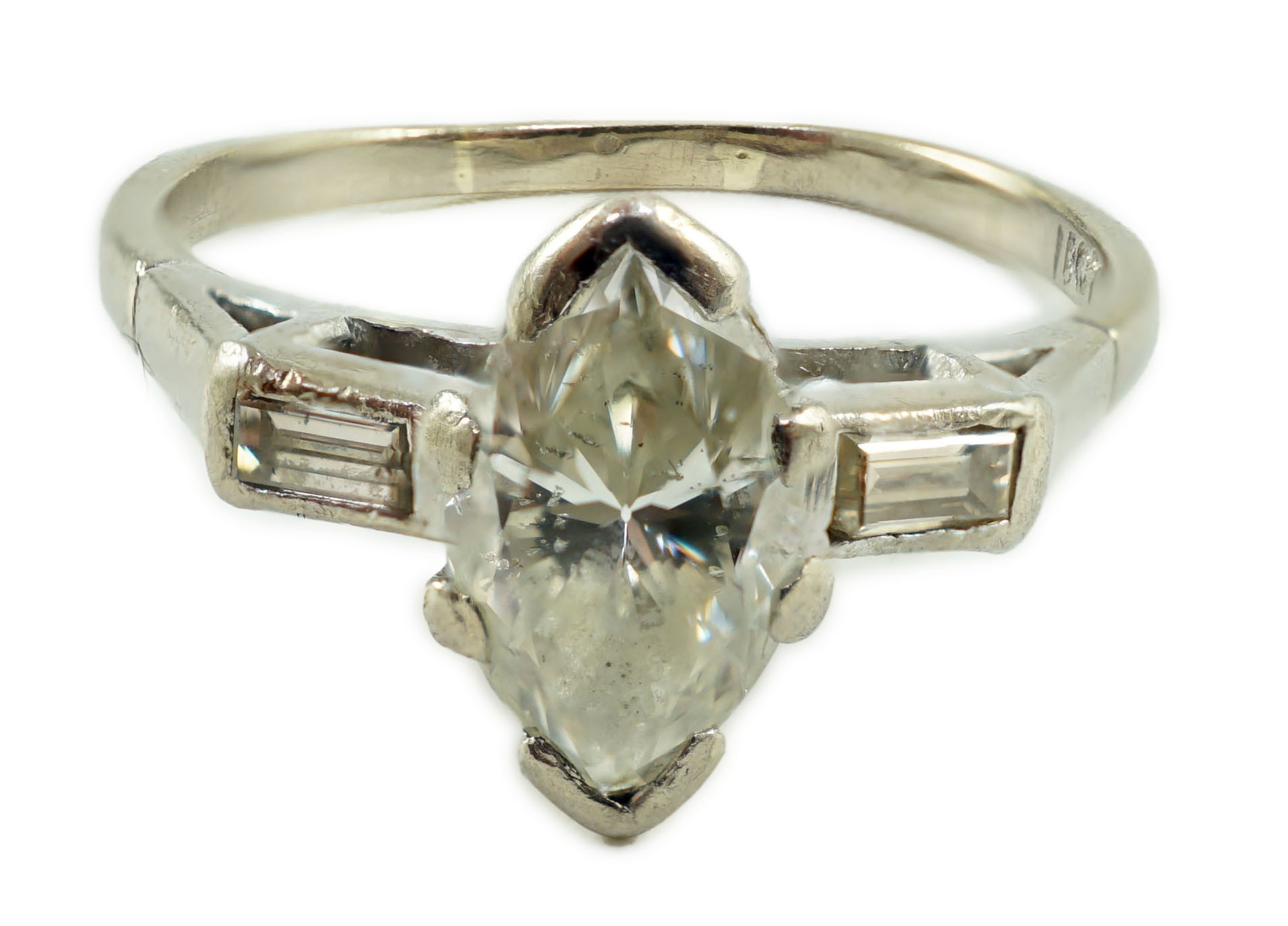 An 18ct white gold and single stone marquise cut diamond set ring, with baguette cut diamond set shoulders